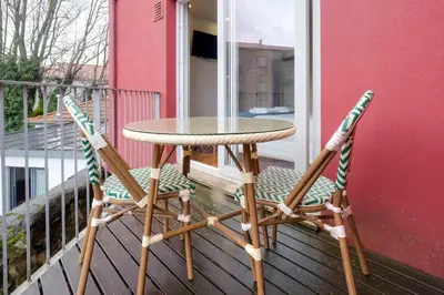 a table and two chairs on a balcony at Magnolia 6 Luxury with AC Metro Downtown Porto in Porto