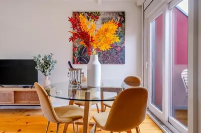 a dining room with a glass table and chairs at Magnolia 6 Luxury with AC Metro Downtown Porto in Porto