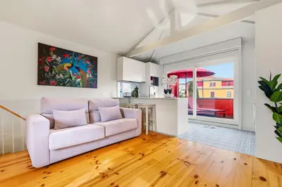 a living room with a couch and a kitchen at Magnolia 6 Luxury with AC Metro Downtown Porto in Porto