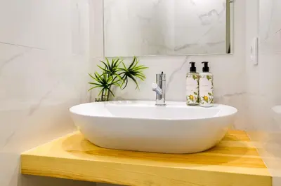 a bathroom with a white sink on a wooden table at Magnolia 6 Luxury with AC Metro Downtown Porto in Porto