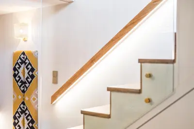 a hallway with a staircase with a patterned stair runner at Victoria Project - Houses - Private Parking in Porto