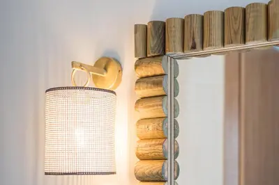 a light hanging on a wall next to a shelf at Victoria Project - Houses - Private Parking in Porto
