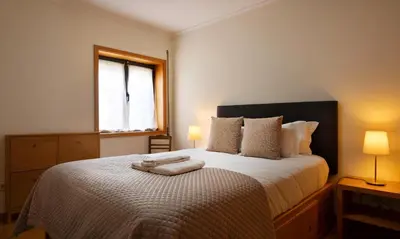 a bedroom with a bed with two towels on it at Wander Unwind - Wine Cellars in Vila Nova de Gaia