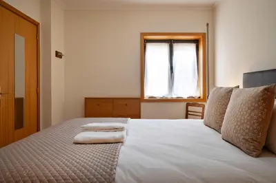 a bedroom with a bed with two towels on it at Wander Unwind - Wine Cellars in Vila Nova de Gaia