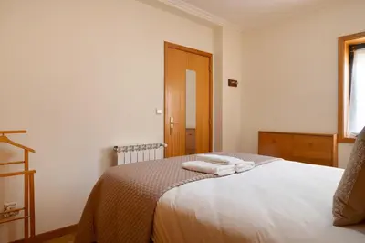 a bedroom with a bed with two towels on it at Wander Unwind - Wine Cellars in Vila Nova de Gaia