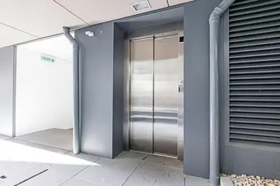a metal elevator in the side of a building at Carlos Alberto Apartment in Porto