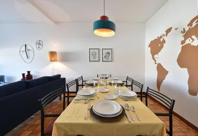 a dining room with a table and a world map on the wall at PinPorto City Center I in Porto