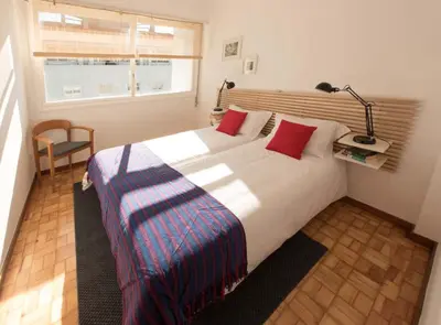 a bedroom with a large white bed with red pillows at PinPorto City Center I in Porto