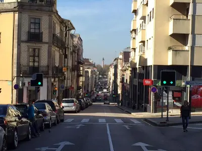 a city street with a green traffic light and buildings at PinPorto City Center I in Porto