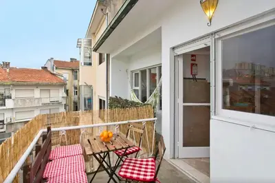 a porch with a table and chairs on a balcony at PinPorto City Center I in Porto