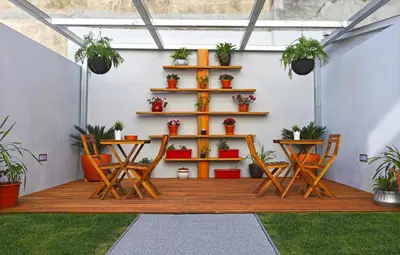 a patio with chairs and a shelf with potted plants at Lusitana Hotel in Porto