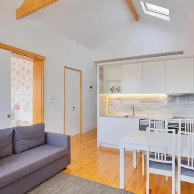 a kitchen and living room with a couch and a table at Charming Apartments in Historic Centre - Inside Porto Apartments 