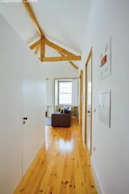 a living room with a couch and a wooden floor at Charming Apartments in Historic Centre - Inside Porto Apartments 
