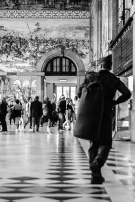 a man walking down a street in a crowd of people at Merc Porto Clérigo's Place in Porto