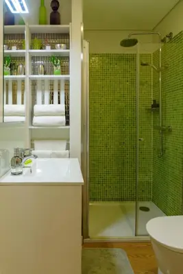 a bathroom with a shower and a sink and a toilet at Cativo Flat in Porto