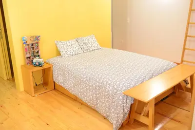 a bedroom with a bed and a wooden table at Loft Taipas in Porto