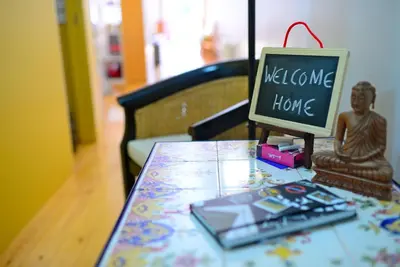 a table with a sign that says welcome home on it at Loft Taipas in Porto