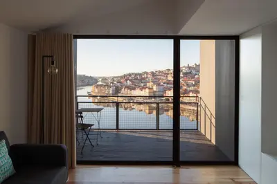 a living room with a view of the water at Oh! Porto Apartments in Vila Nova de Gaia