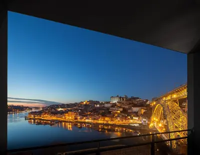 a view of a river and a city at night at Oh! Porto Apartments in Vila Nova de Gaia