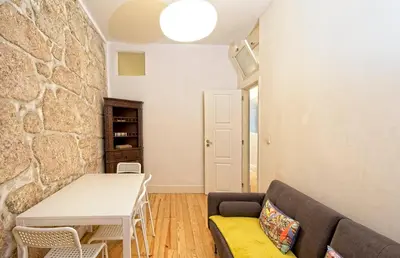 a living room with a table and a couch at Ribeira Smart Flat in Porto