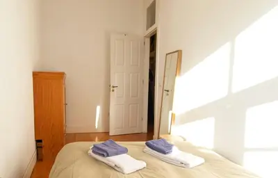 a bedroom with a bed with two towels on it at Ribeira Smart Flat in Porto