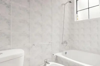 a bathroom with a tub and a toilet and a sink at Ribeira Smart Flat in Porto
