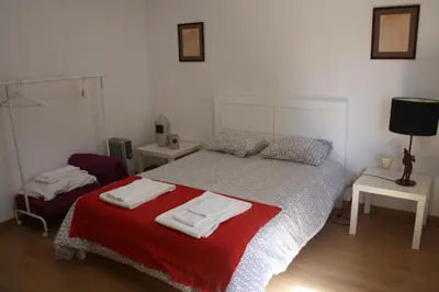 a bedroom with a bed with two towels on it at Alegria Rooms in Porto