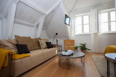a living room with a couch and a table at Belomont52 Guest House in Porto