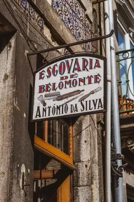 a sign on the side of a building at Belomont52 Guest House in Porto
