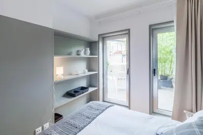 a bedroom with a bed and a window at CdC Apartments by Casa do Conto in Porto