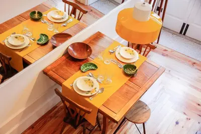 two wooden tables with plates and silverware on them at Studio 77 in Porto