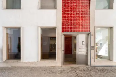 three windows of a building with a red brick at VIVA Aliados Spacious & Bright Flat in Porto