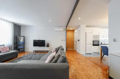 a hotel room with a bed and a sink and a bathroom at Feel Porto Vintage Townhouses in Porto