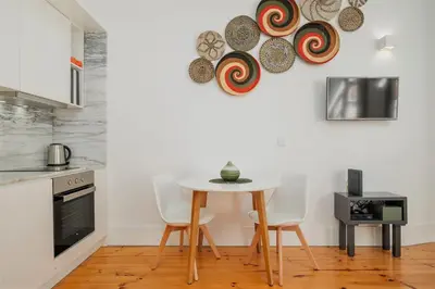 a kitchen with a table and some plates on the wall at Flores Street Apartments in Porto