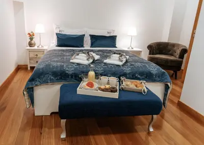 a bedroom with a bed with a tray of food on it at Authentic Porto Apartments in Porto