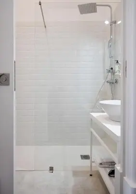 a white bathroom with a shower and a sink at Oporto Comfort Charming Cedofeita - Free Parking in Porto