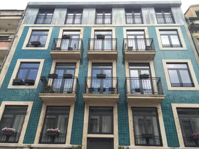 a tall building with balconies on the side of it at I love alegria in Porto