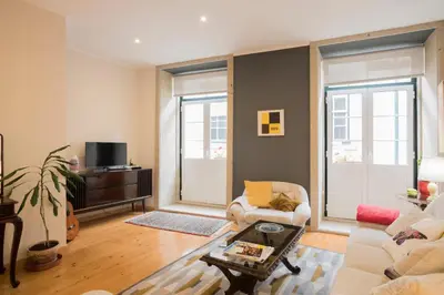 a living room with a couch and a table at Casa do Cristelo in Porto