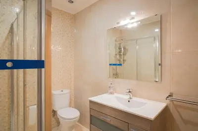 a bathroom with a sink and a toilet and a shower at Casa do Cristelo in Porto