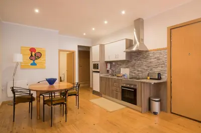 a kitchen and dining room with a table and chairs at Casa do Cristelo in Porto