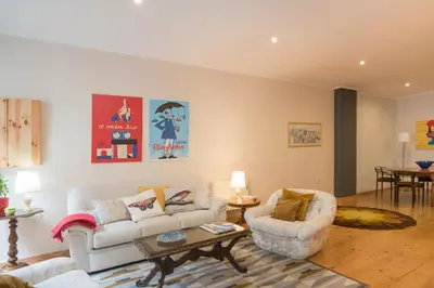 a living room with two couches and a table at Casa do Cristelo in Porto