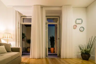 a living room with white curtains and a couch at Casa d'Alma by Oporto Soul in Porto