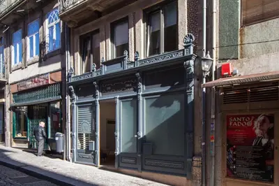a man standing in front of a store on a street at Oporto Local Studios in Porto