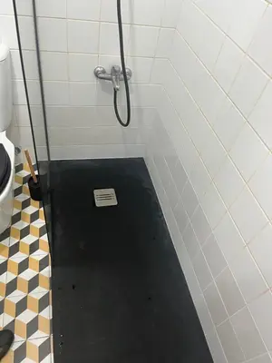 a shower with a black floor in a bathroom at Design Apartment Porto Downtown in Porto