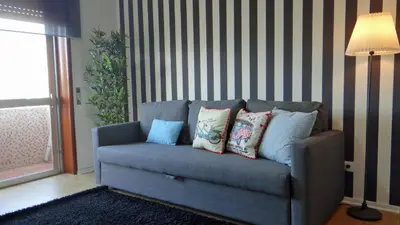 a couch with pillows on it in a living room at Design Apartment Porto Downtown in Porto