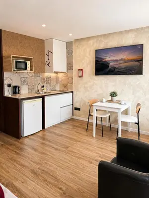 a bedroom with a bed and a wall with a mural at Lounge Inn Guest House in Porto