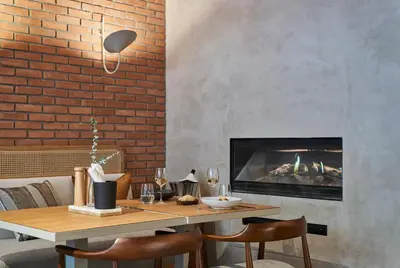 a dining room with a table and a fireplace at PortoBay Teatro in Porto