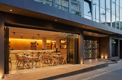 a restaurant with tables and chairs in front of a building at PortoBay Teatro in Porto