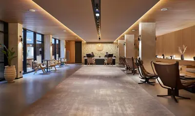 a lobby with a table and chairs in a building at PortoBay Teatro in Porto