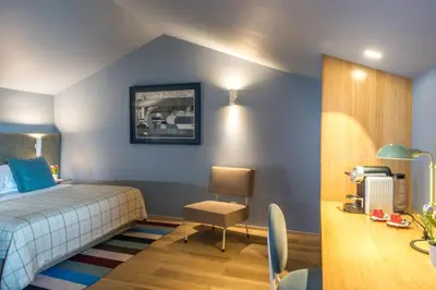 a white bathroom with a toilet and a sink at The Editory House Ribeira Porto Hotel in Porto